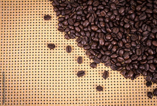 coffee beans border on wickerwork background