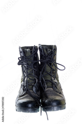 Old and dusty combat boots isolated on white.