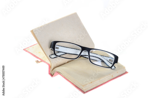 Open mulberry notebook and eyeglasses isolated on white.