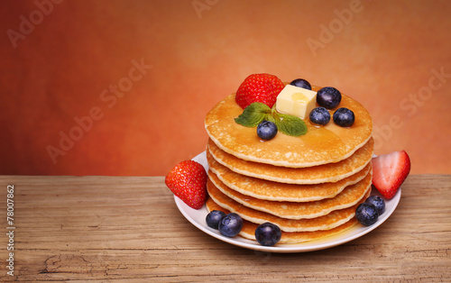 Stack of pancakes with fresh blueberry, strawberry
