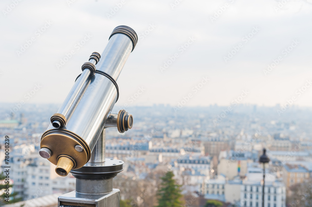 Tourist telescope over viewing Paris  at Sacre Coeur
