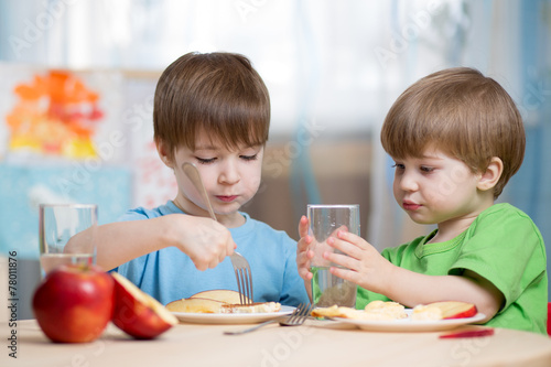 children boys eating healthy food at home