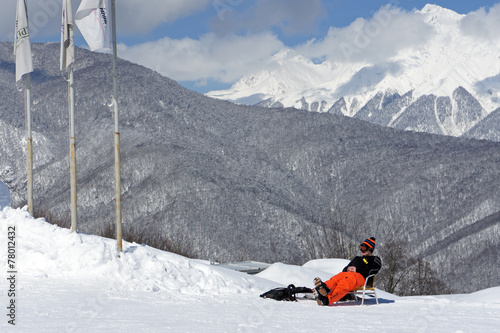 the skier rests on a background of mountains