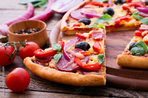 Delicious pizza served on wooden table