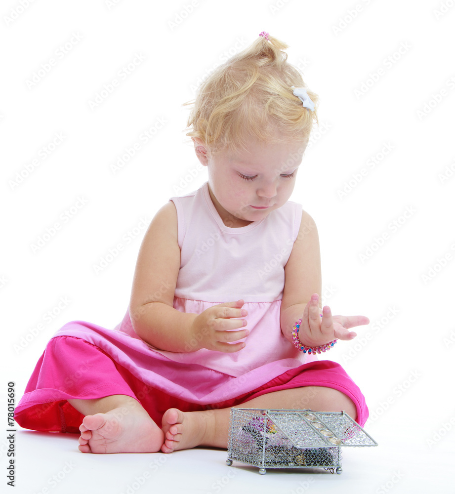 charming little girl who is considering jewelry she got out of t