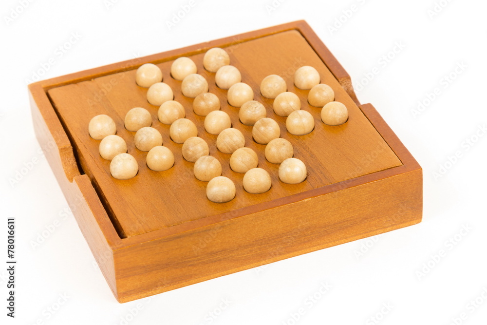 Peg solitaire wooden puzzle, isolated image Peg solitaire wooden puzzle, isolated image