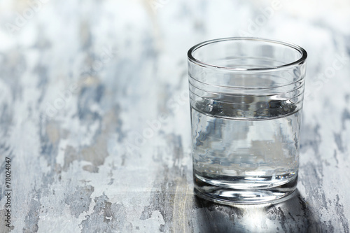 Wallpaper Mural Glass of clean mineral water on old color wooden background Torontodigital.ca