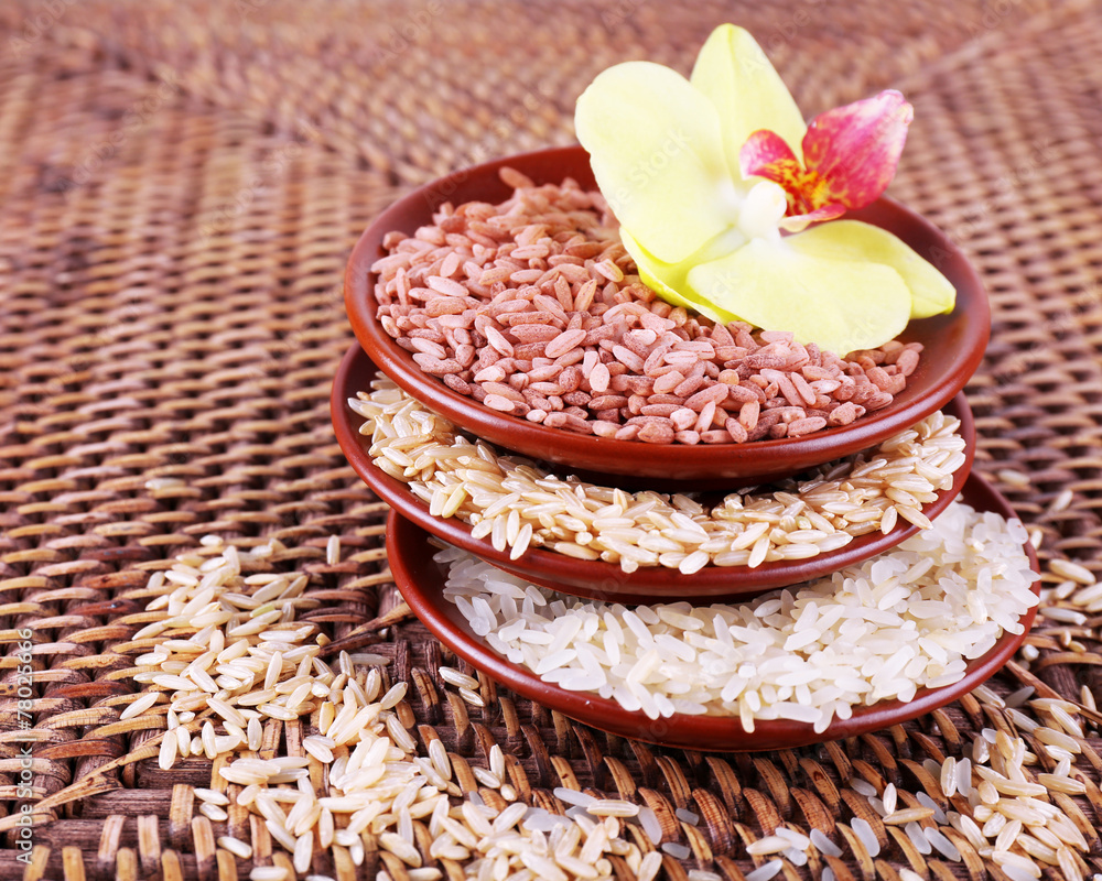 Naklejka premium Different types of rice in bowls on wicker background