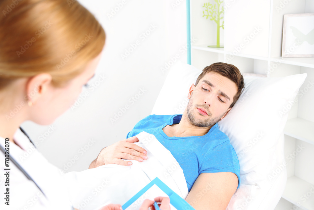 Fototapeta premium Doctor filling medical report for her patient close up
