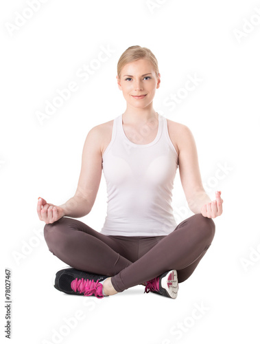 Attractive young woman in lotus position. Woman practicing yoga