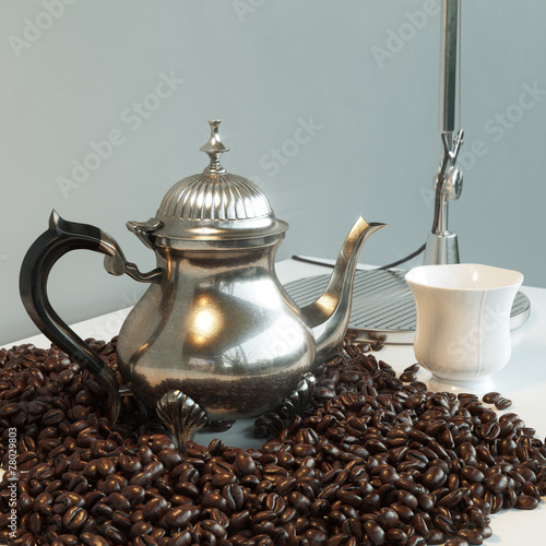 Vintage pot with cup and roasted cooffee beans under the lamp
