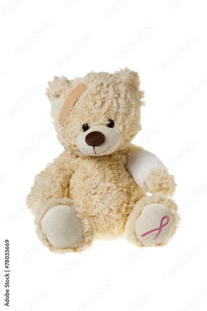 injured teddy bear with bandages and aids symbol