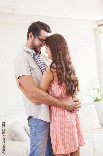 Hipster couple smiling and hugging