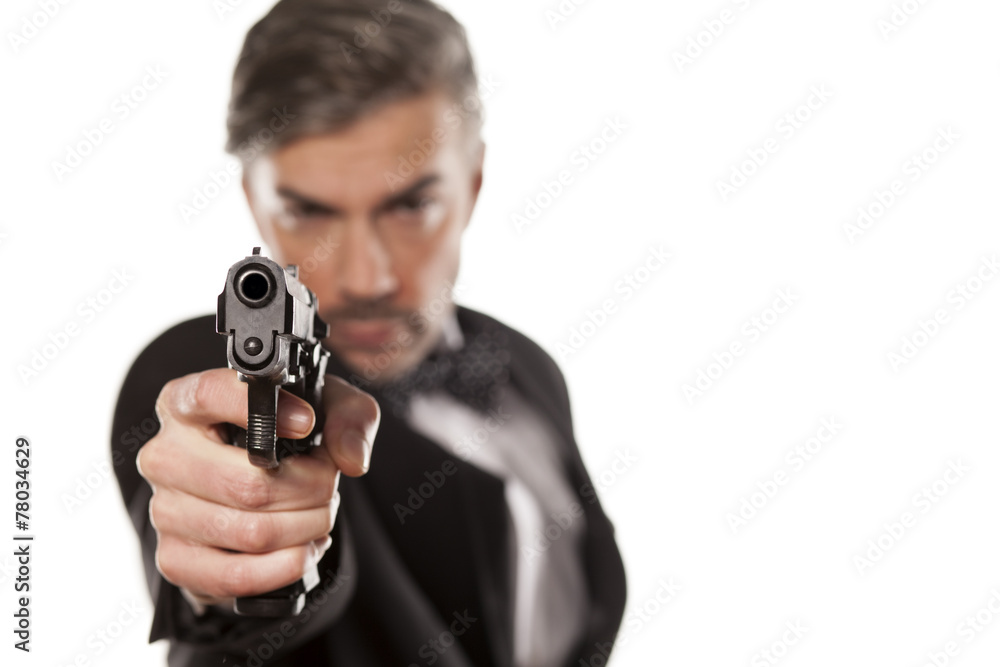 handsome man in a suit aim with a gun handsome man in a suit aim with a gun