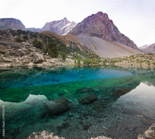 Fototapeta Naklejka Na Ścianę i Meble -  deep blue lake in Fann mountains at sunrise