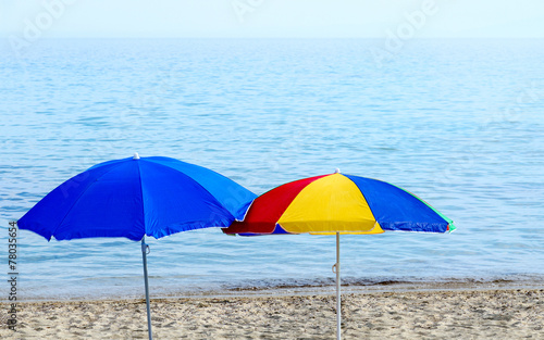 Bright beach umbrellas on the seashore