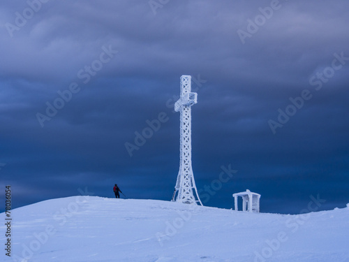 Summit cross and hiker, mount Catria, Winter, Apennines,Italy photo