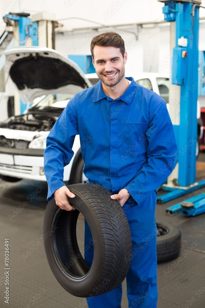 Mechanic holding a tire wheel