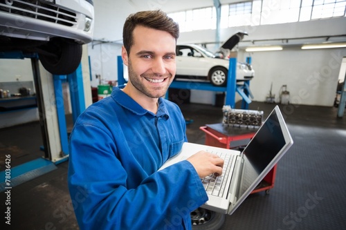 Mechanic using a laptop to work