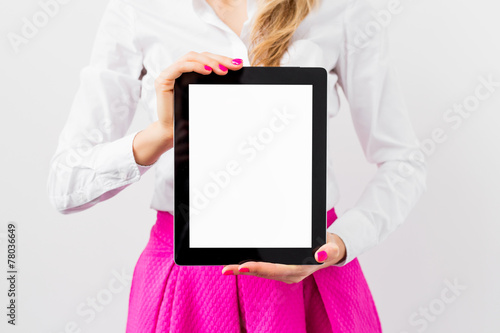 Woman holding ipad with empty white screen vertically