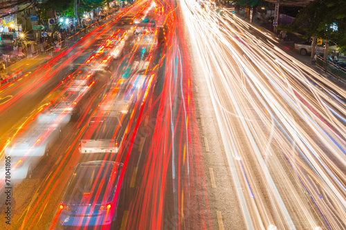 light streams from ongoing traffic in business district road