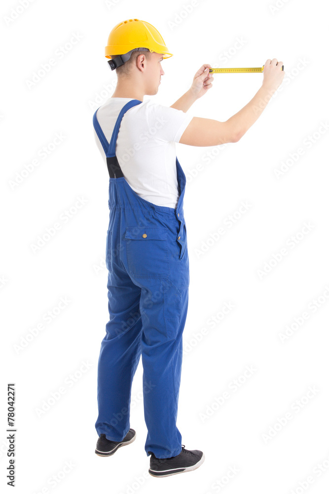back view of man builder in blue uniform holding measure tape is
