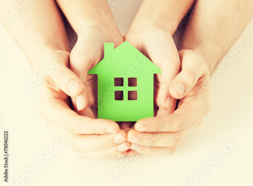 couple hands holding green house