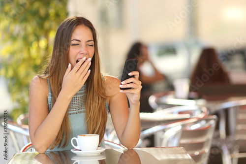 Woman yawning while is working at breakfast in a restaurant