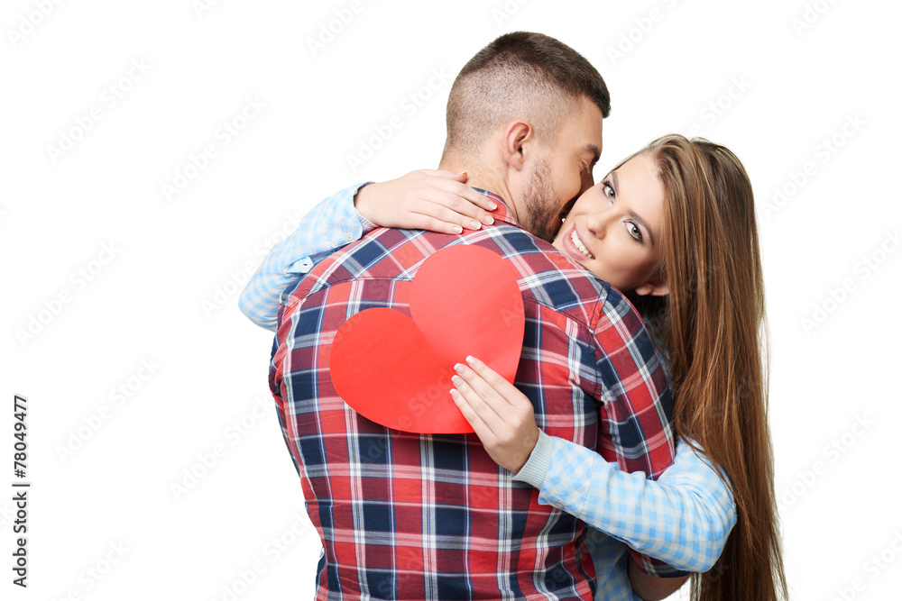 Man kissing beautiful woman with heart card