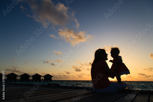 mother and little daughter having fun at sunset
