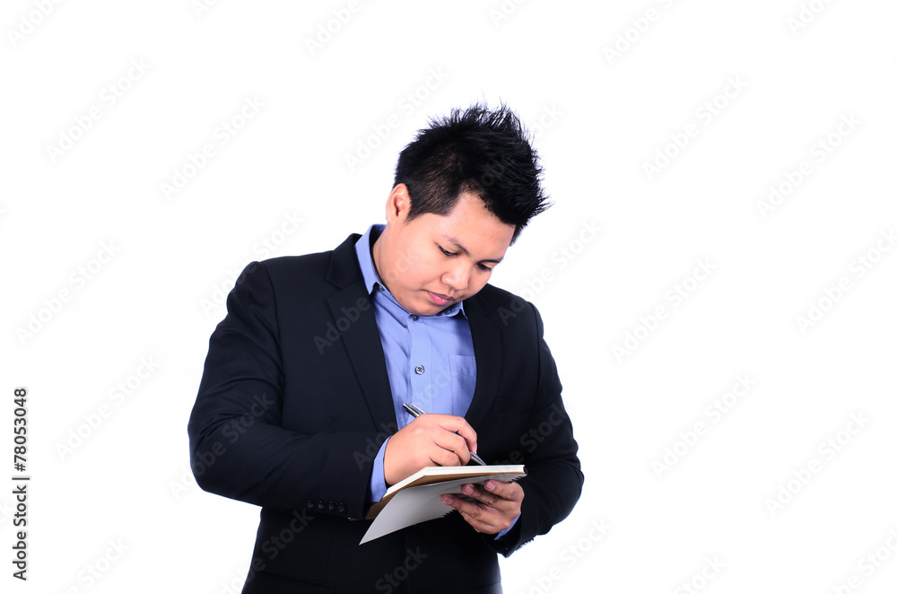 Young smiling Asian businessman taking notes isolated on a white Young smiling Asian businessman taking notes isolated on a white