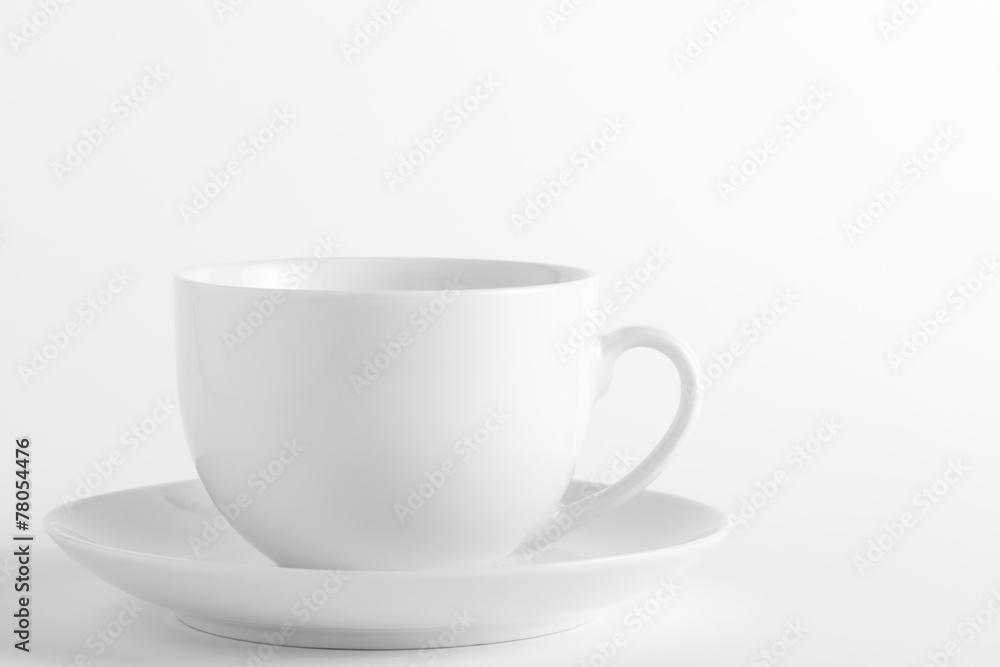 White cup and saucer on a white background White cup and saucer on a white background