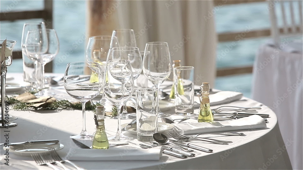 Served table in a restaurant on the beach in Europe at sunset Served table in a restaurant on the beach in Europe at sunset