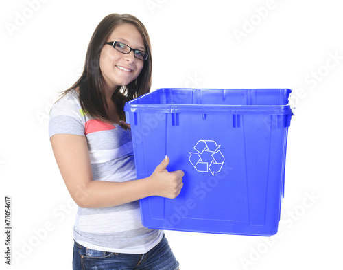 Young woman carrying a plastic container full with empty recycla photo