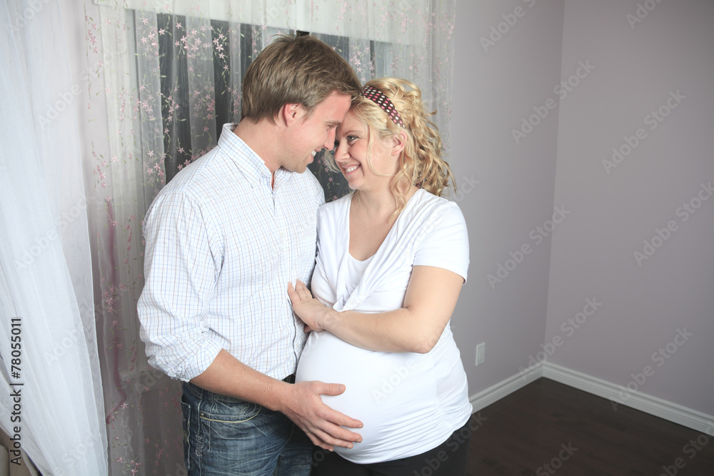 A pregnant woman with his boyfriend on the baby room A pregnant woman with his boyfriend on the baby room