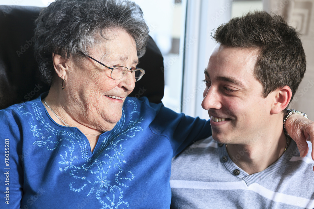 A grandchild with his grandmother in his room A grandchild with his grandmother in his room