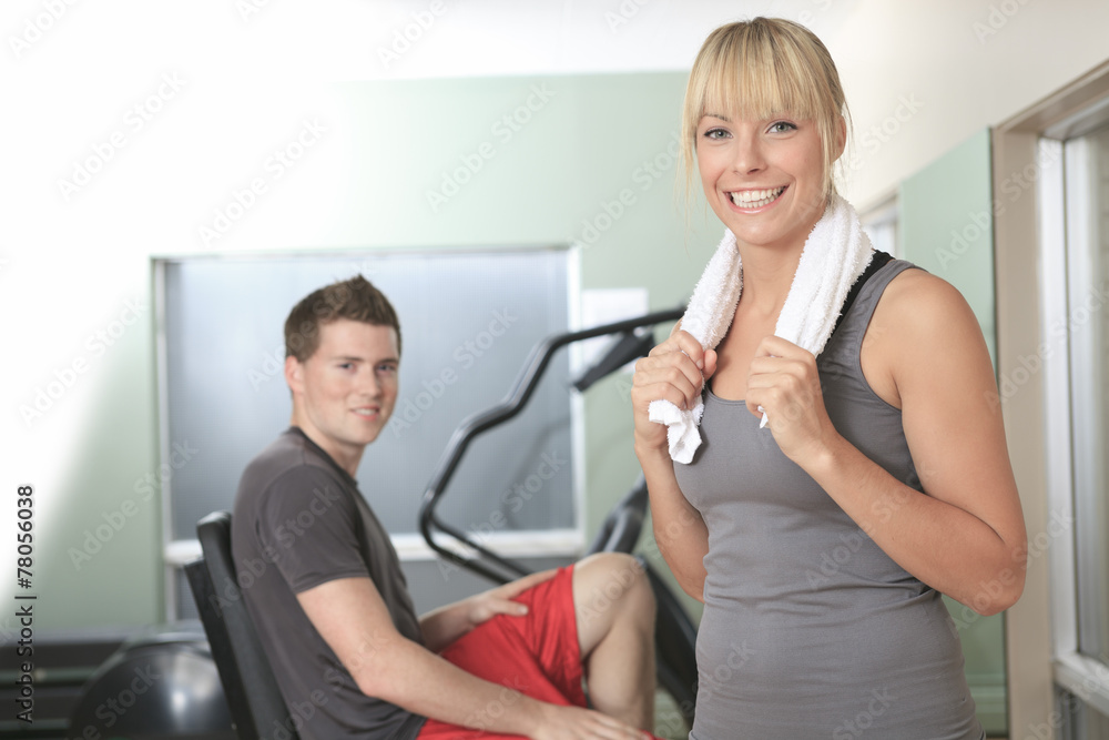 Young athletic couple in gym on training Young athletic couple in gym on training