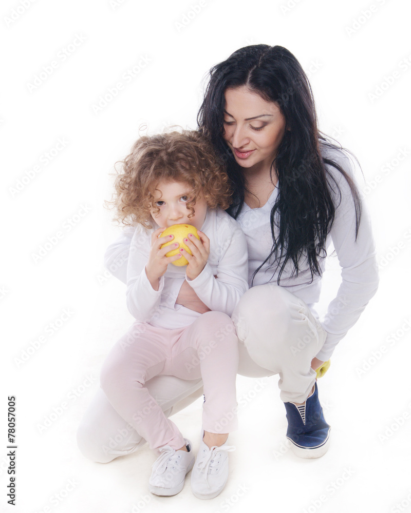 The child with mother holding apple isolated The child with mother holding apple isolated
