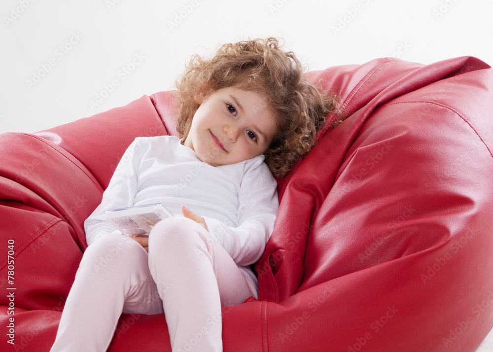 the child sitting on the furniture frame less isolated on white the child sitting on the furniture frame less isolated on white