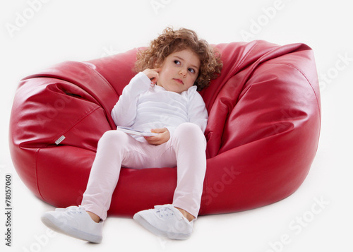 the child sitting on the furniture frame less isolated on white