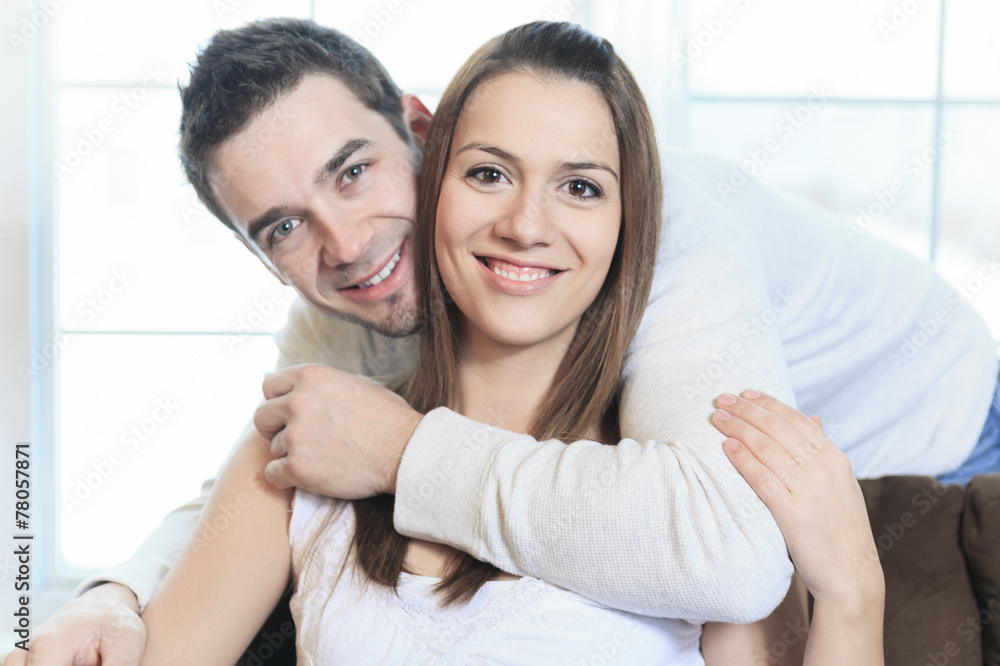 An happy couple at home relaxing in sofa An happy couple at home relaxing in sofa