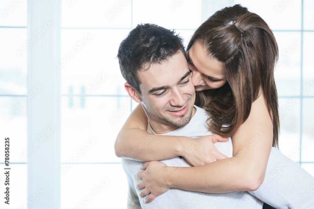 Fototapeta premium A couple having great time close to the window