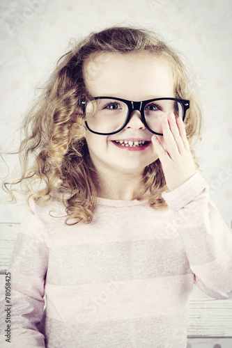 Smiling little girl with glasses photo