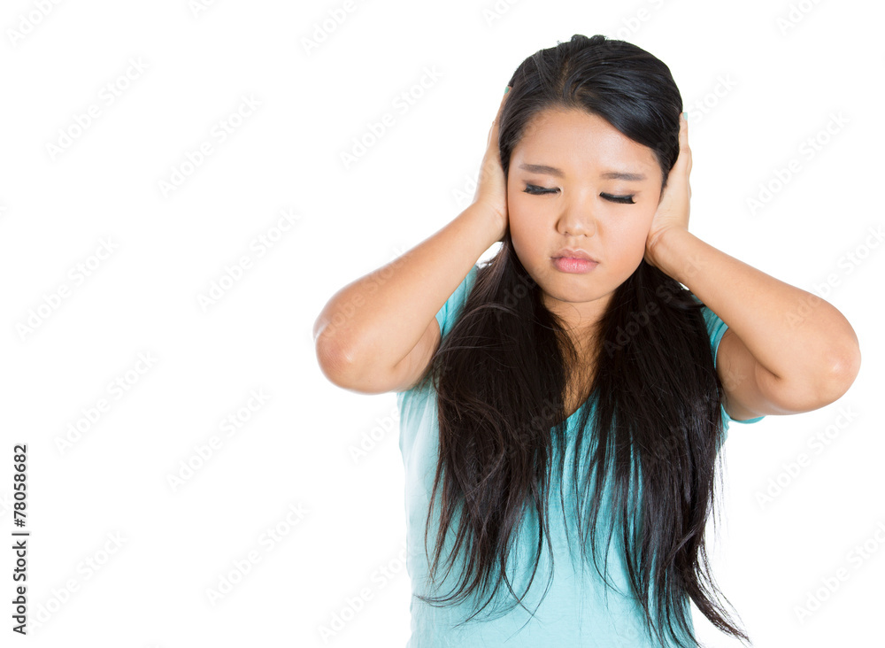 Teenager girl covering ears with hands on white background Teenager girl covering ears with hands on white background