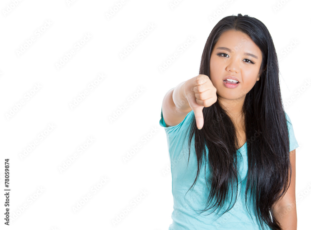 Unhappy woman giving thumbs down gesture looking displeased Unhappy woman giving thumbs down gesture looking displeased