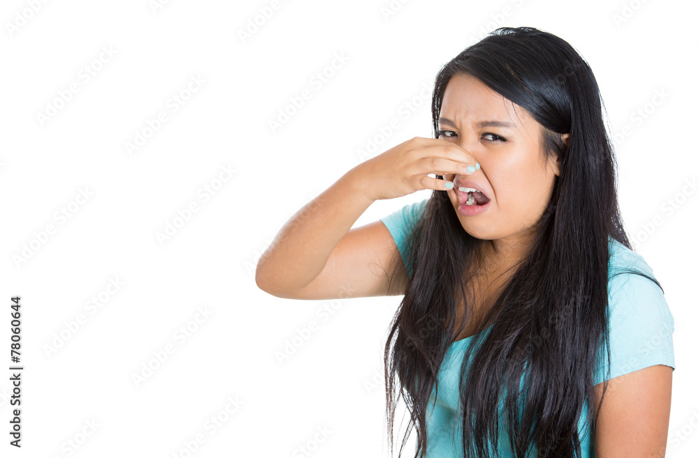 Side profile young woman covers pinches her nose bad smell Side profile young woman covers pinches her nose bad smell