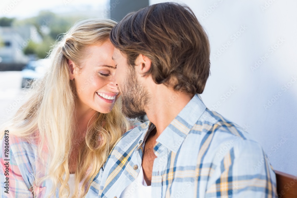 Attractive couple sitting on bench Attractive couple sitting on bench