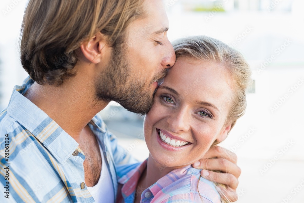 Fototapeta premium Attractive couple standing and hugging