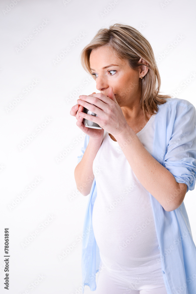 forty years old pregnant woman isolated and drinking with mug forty years old pregnant woman isolated and drinking with mug