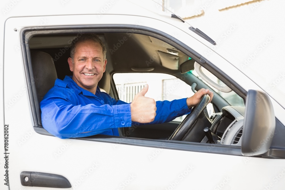 Delivery driver showing thumbs up driving his van